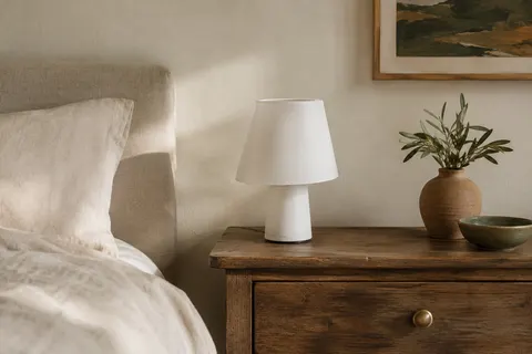 Lampe de table blanche ROOTRO à commande tactile, posée sur une table de chevet en bois.
